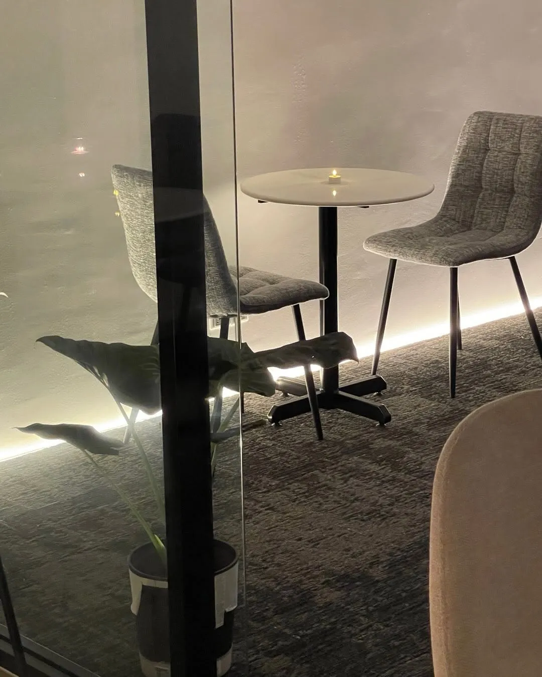 Cozy cafe corner with modern chairs and ambient lighting.