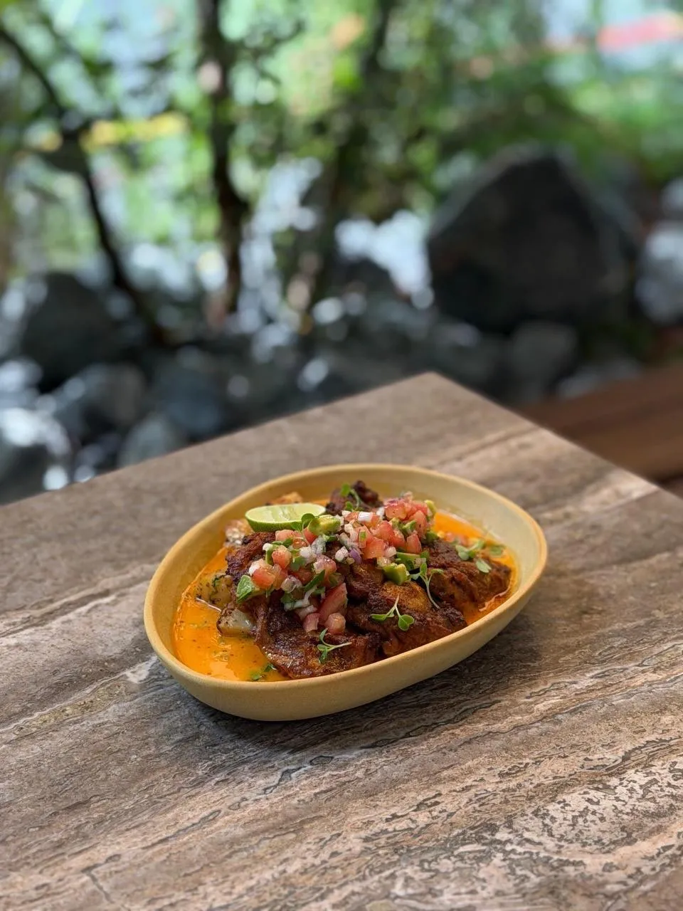 Savory dish topped with fresh ingredients set on a table.