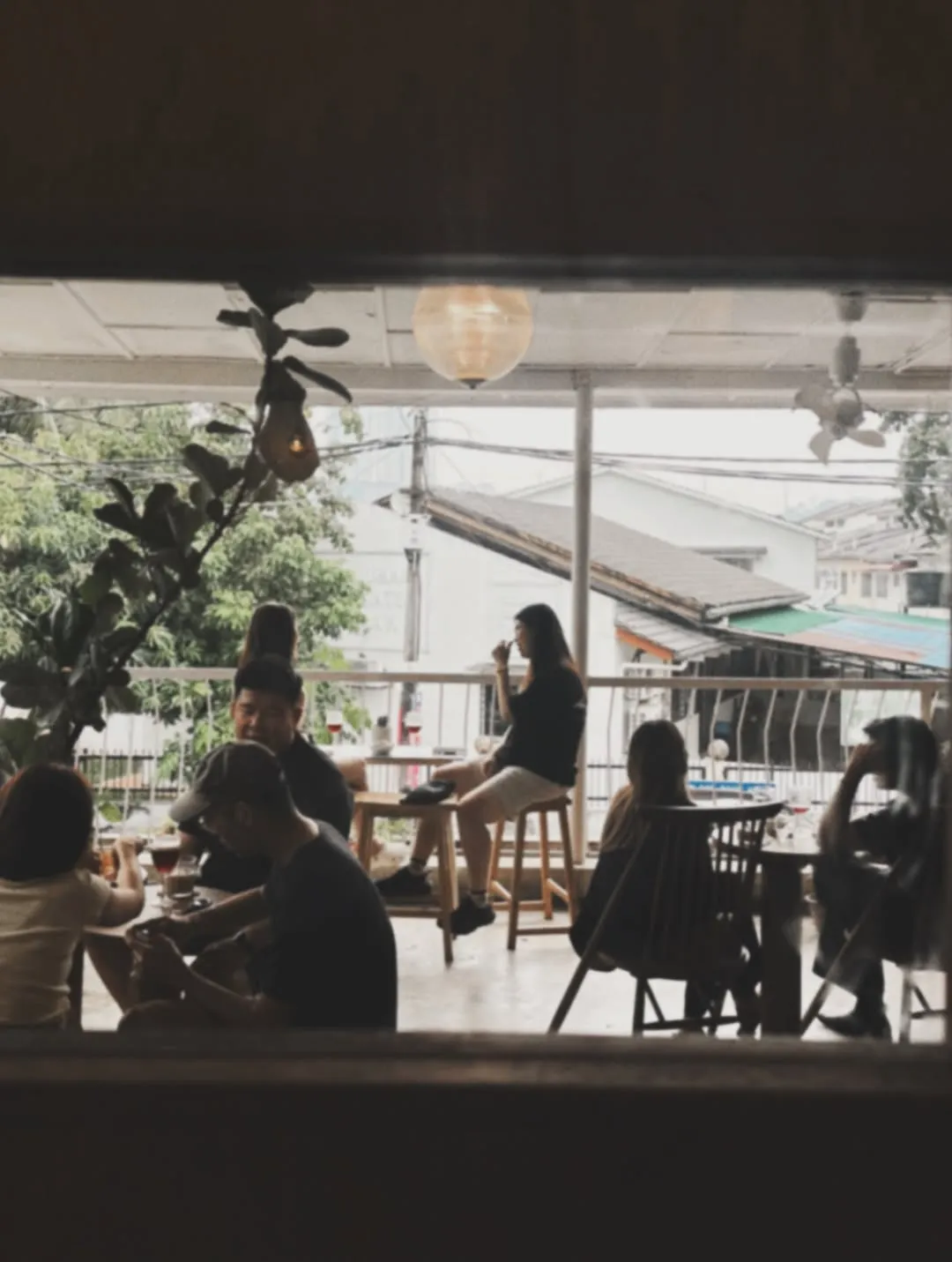 Cozy cafe scene with patrons enjoying coffee and quiche on a rainy day.
