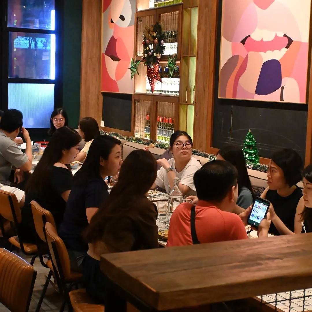 Bistro-style dining scene filled with guests enjoying their meals together.