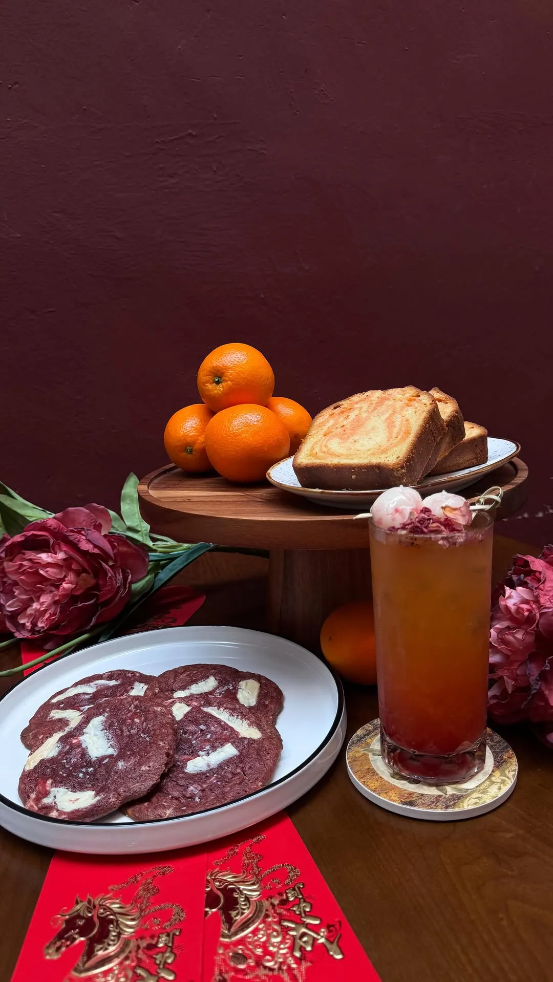 Festive spread with oranges, toast, and drink layered with pink and orange hues.