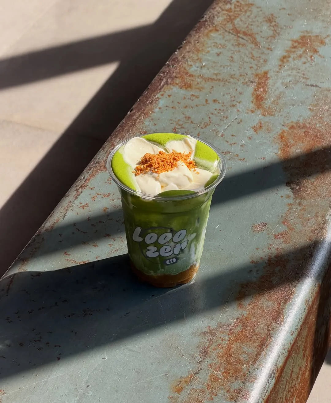 Banana matcha drink topped with salted cheese cold foam.