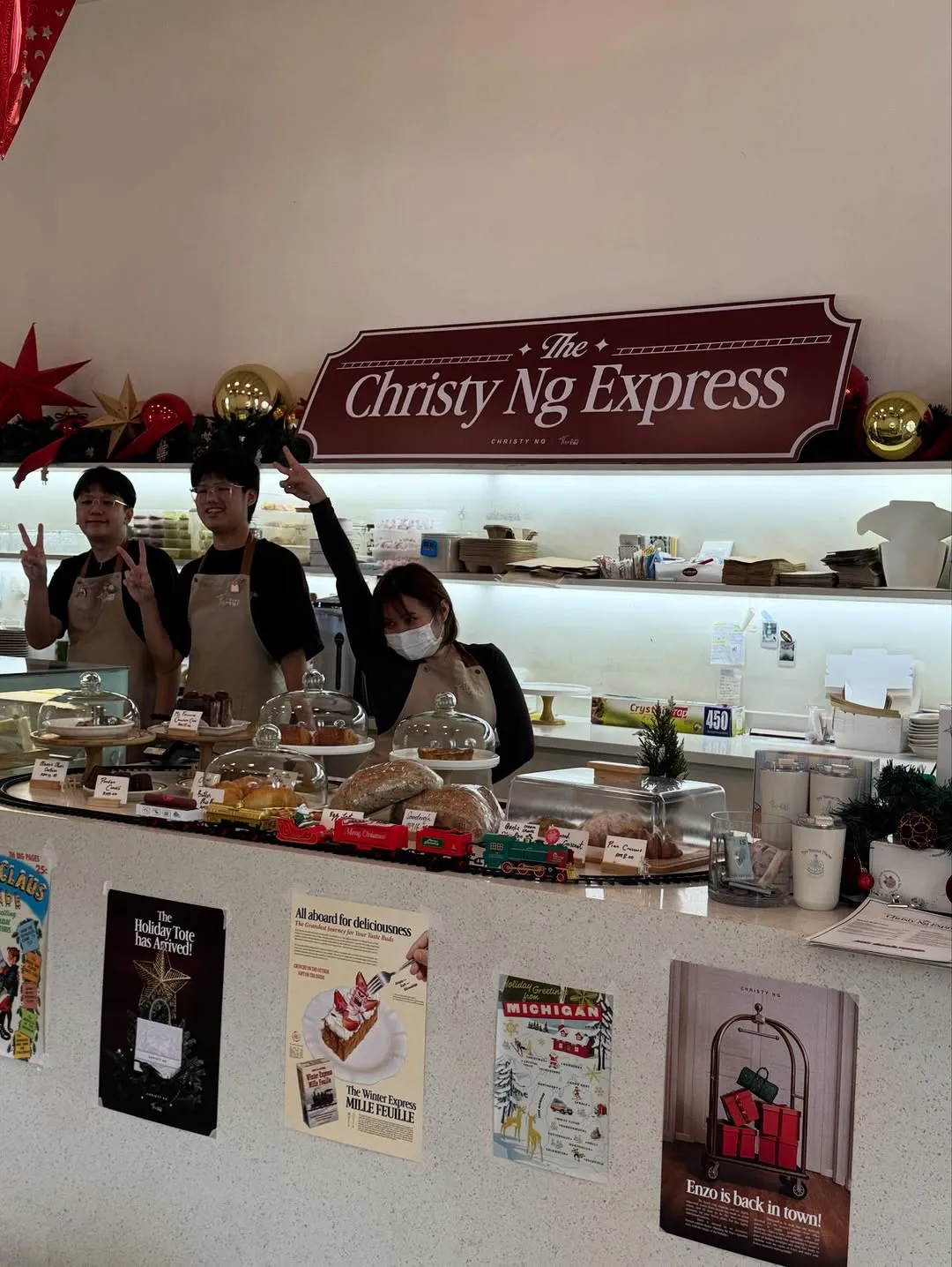 Café staff posing behind the counter with festive decorations.