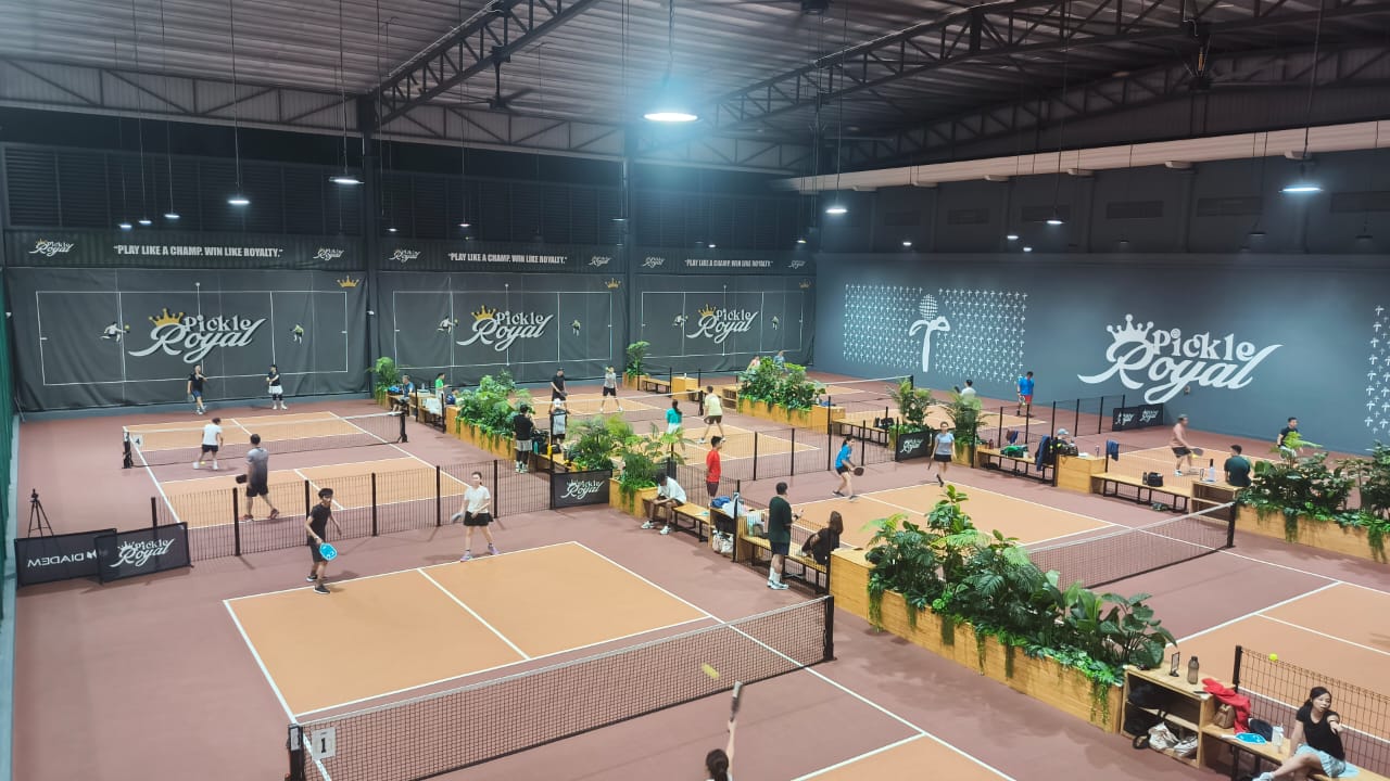 Four indoor pickleball courts with rubber surface at Pickle Royal @ Tropicana