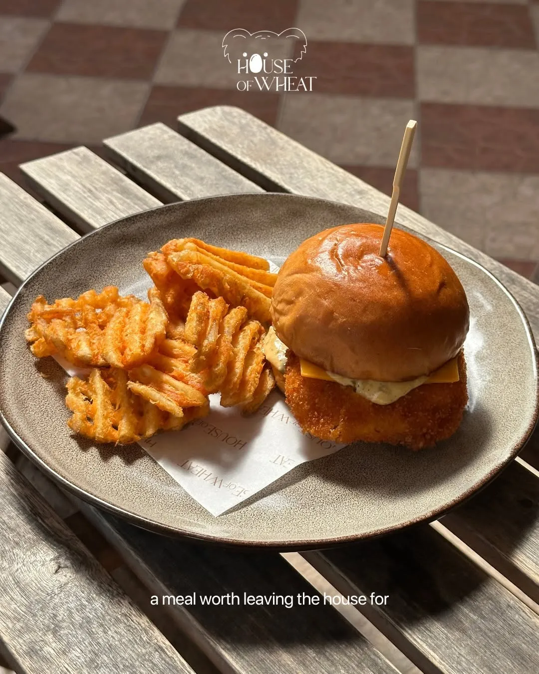 Crispy battered fish burger served with waffle fries.