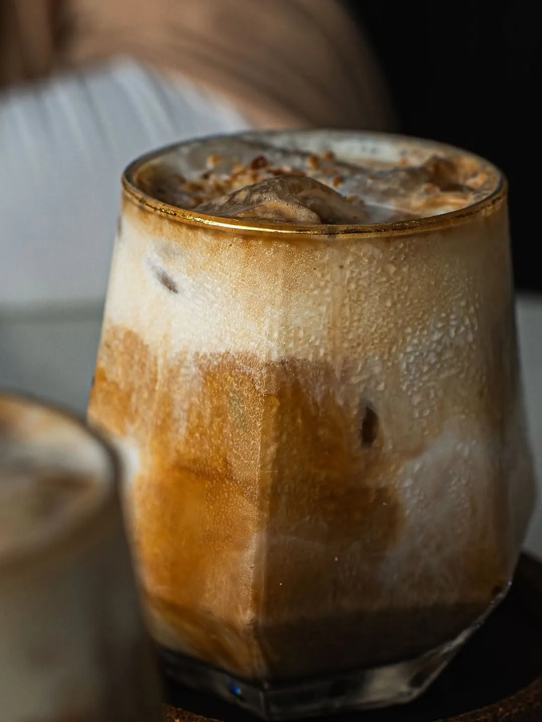A close-up of a chilled iced coffee drink with layered textures.