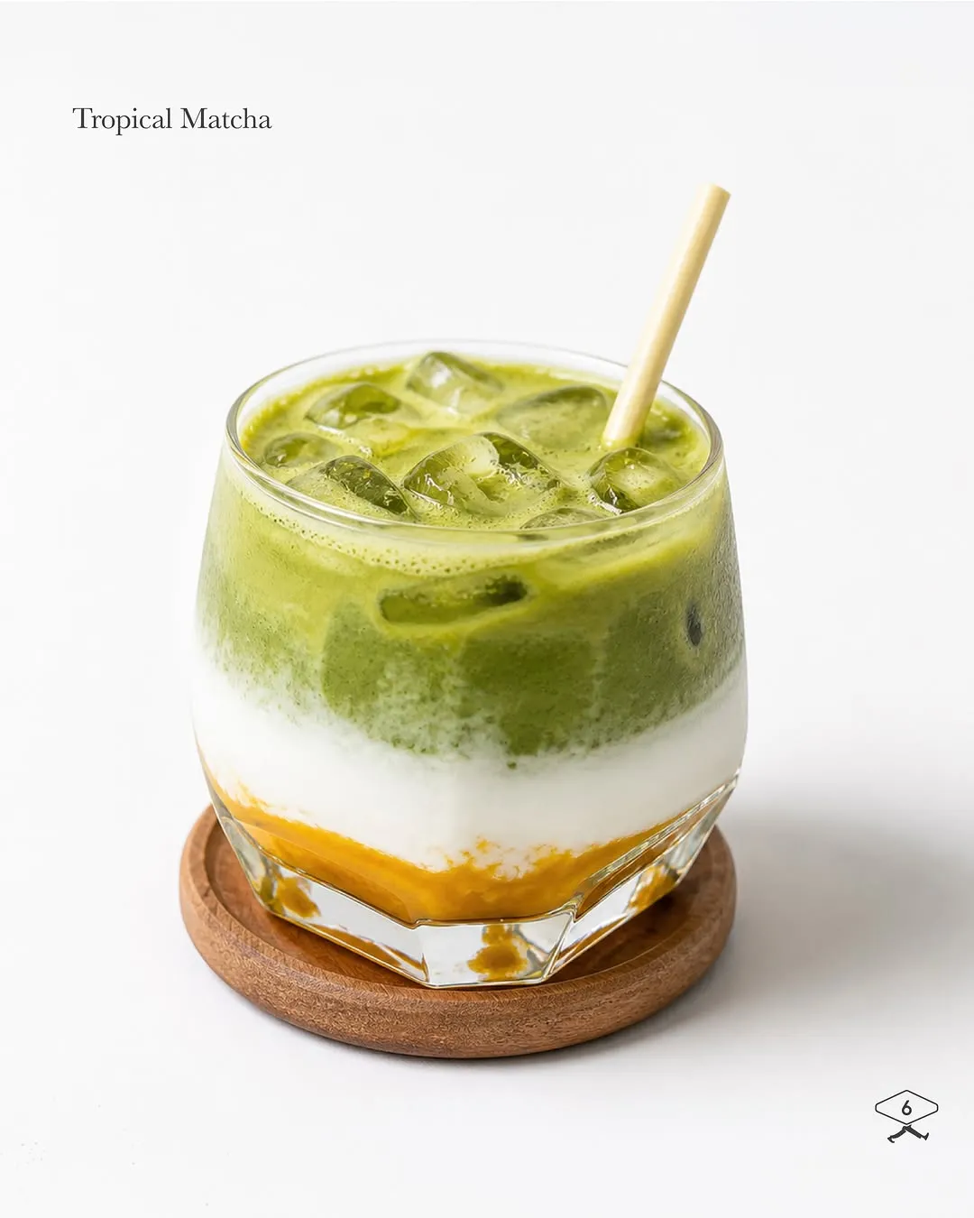 Iced Tropical Matcha layered with coconut and mango puree in a glass.