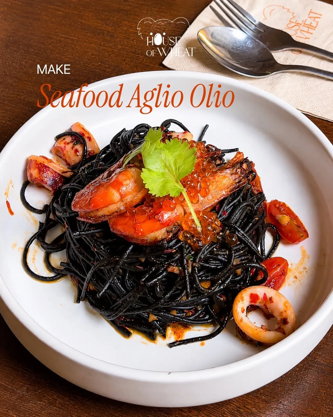 Black squid ink pasta topped with seafood and garnished.