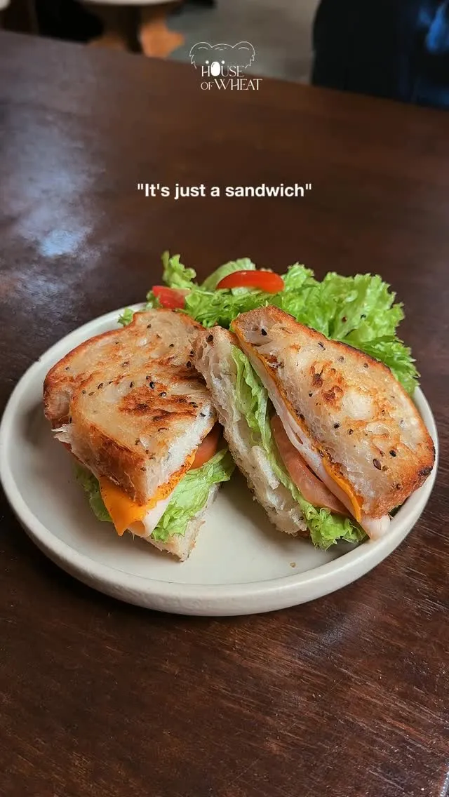 Grilled sandwich with lettuce, cheese, and turkey on a plate.