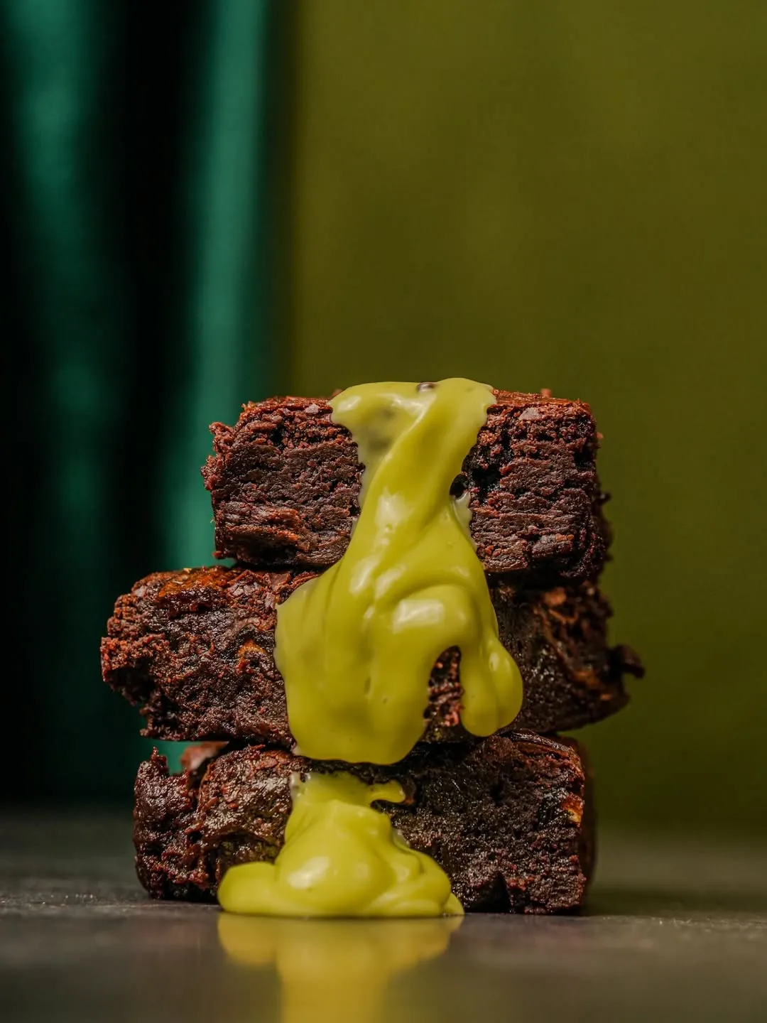 Three brownies with gooey kaya sauce oozing down.